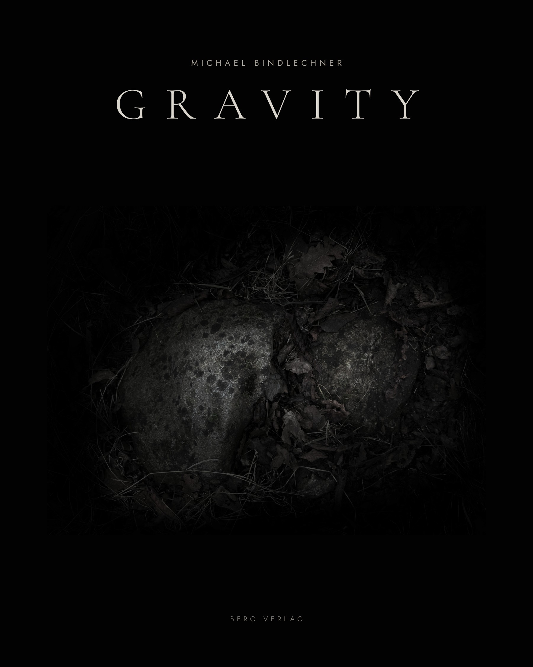 Cover of Gravity by Michael Bindlechner, Berg Verlag: two stones in the dark